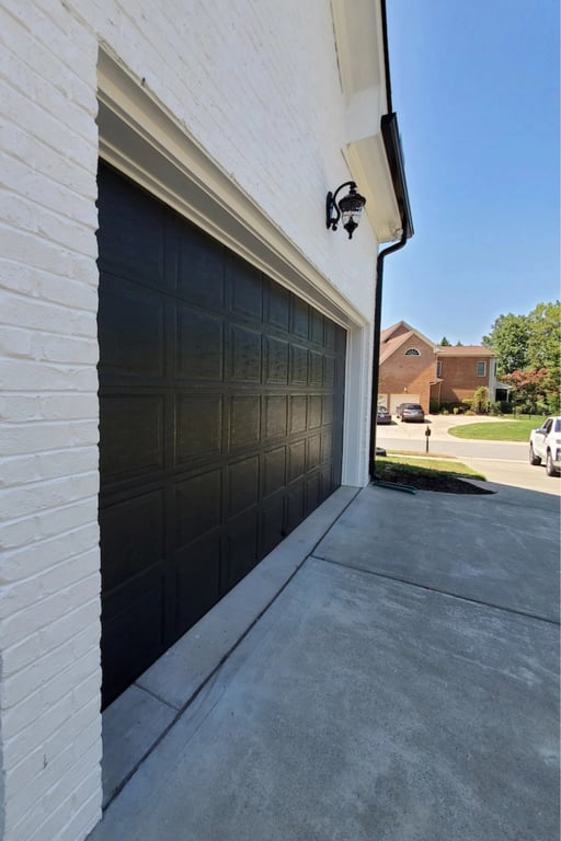 Side view of a cleaned black garage door in Cary, NC.
