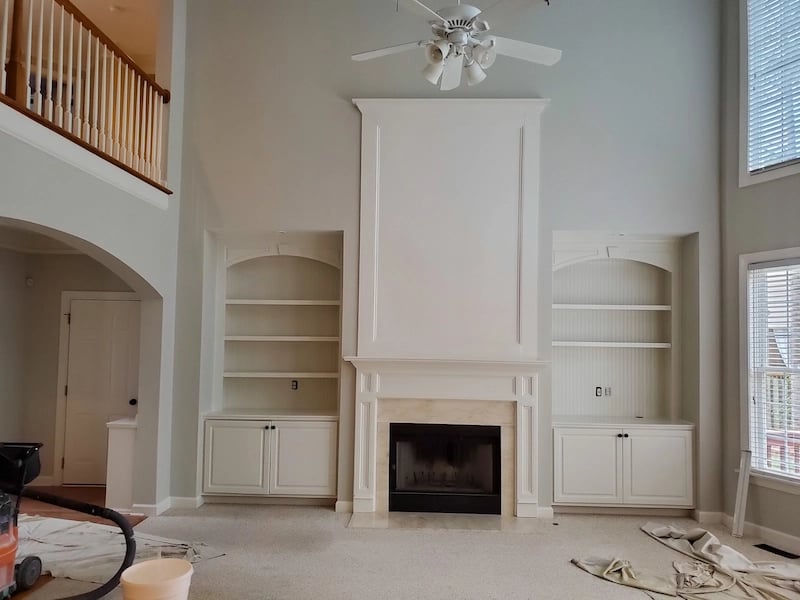 Setting up to paint the inside of the main floor of a large living room, foyer and upstairs hall in a house with a open main floor plan.