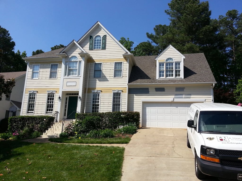 Paint samples on a home exterior ready for painting after siding repairs in Raleigh.