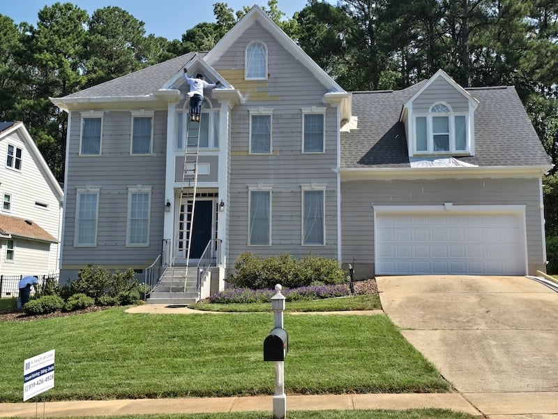A Touch of Color Painting staff completing exterior paint preparations, landscape protection and covering for a clean, safe, and sealed work space.
