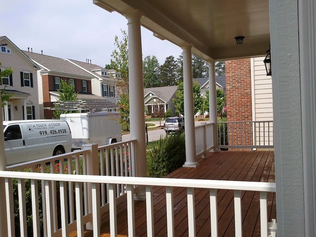 Stained wood front porch by A Touch of Color Painting and General Contracting.