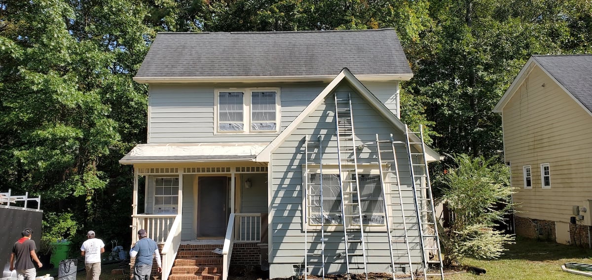 A Touch of Color Painting staining a cedar home in Raleigh, NC.