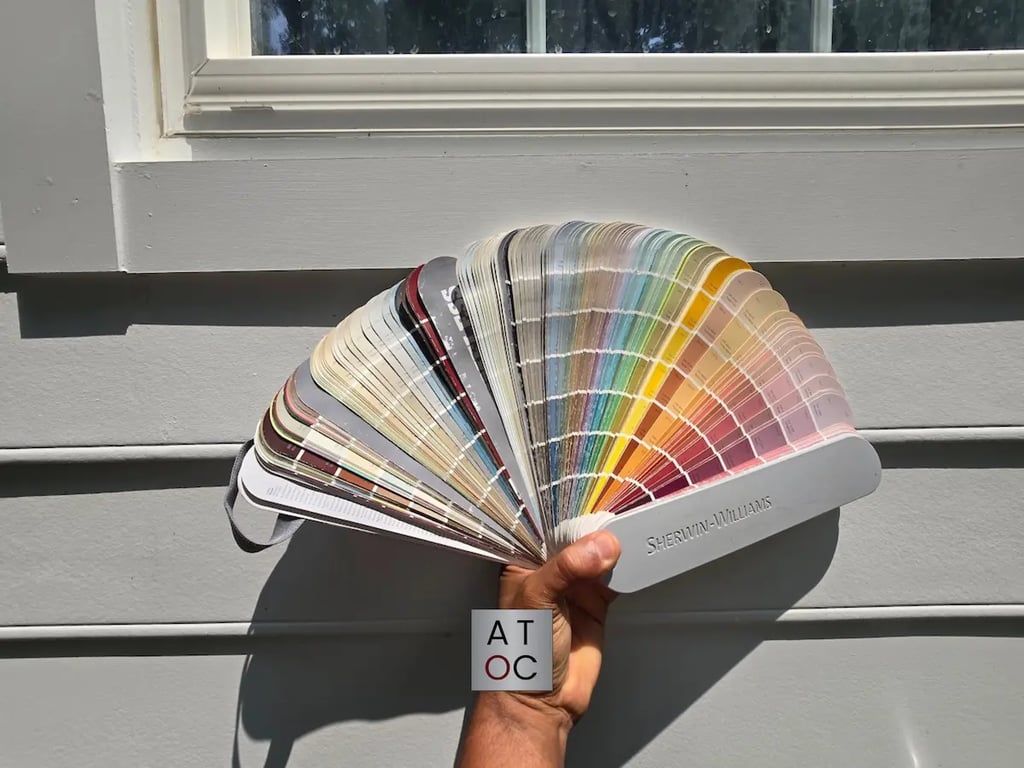 Holding a Sherwin-Williams color fan deck up against exterior siding to show how contrasting colors compare.