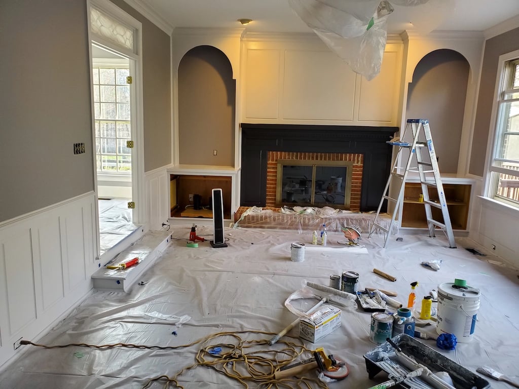A Touch of Color Painting professional painters applying Sherwin-Williams ProClassic to bookshelves and a mantel in a high-end Raleigh home in the Devon subdivision to ensure a non-stick, uniform finish.
