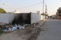 Trash piles up outside schools in Kirkuk, concerning teachers