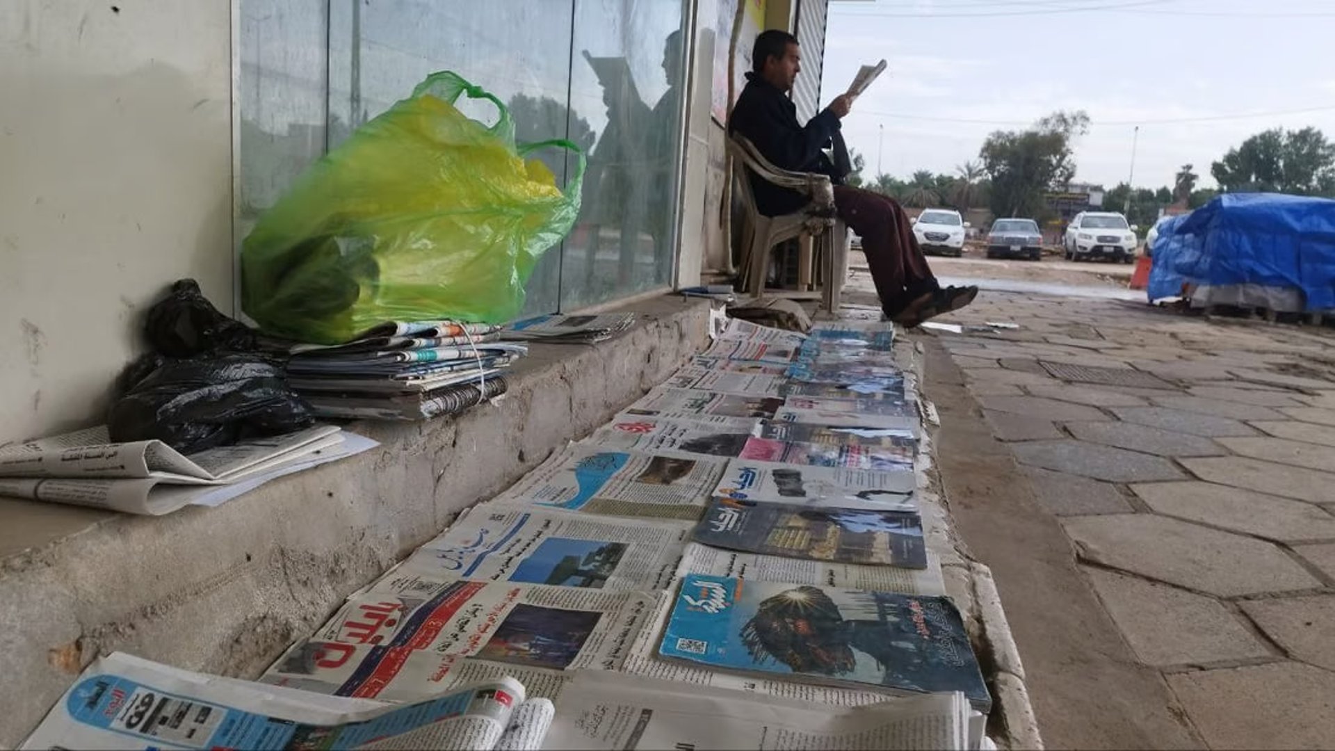 A newspaper vendor preserves tradition in Hillah amid changing reading habits