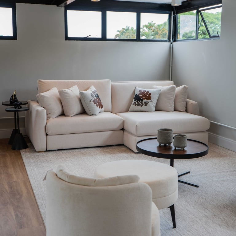 Sofá Maldivas off-white em formato L com chaise e almofadas decorativas em sala de estar clara
