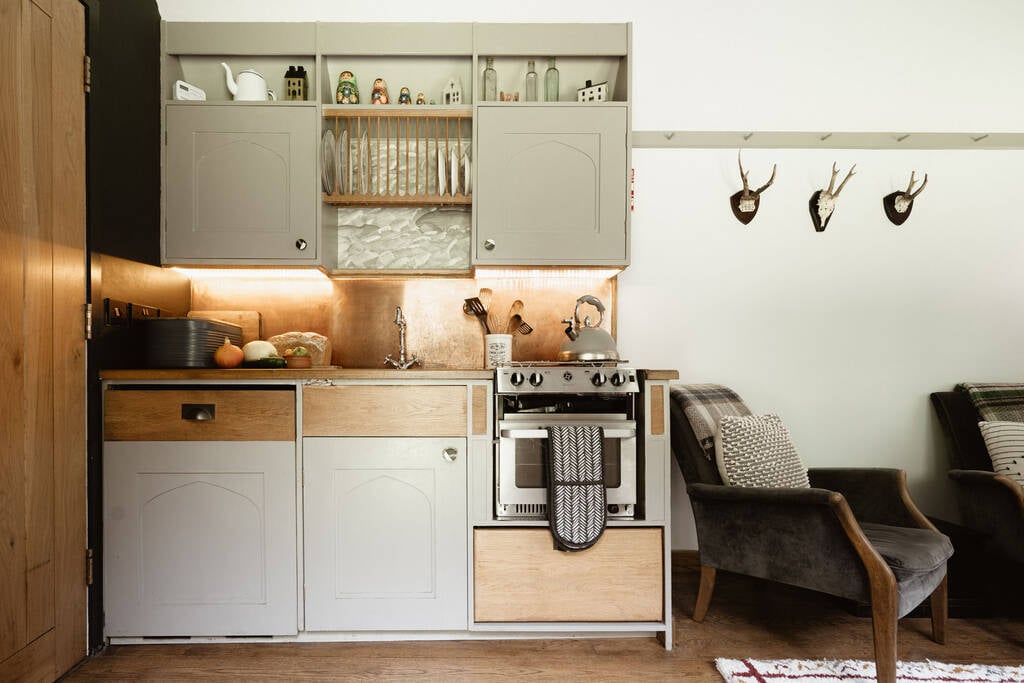 Kitchen equipped with an oven, stove, kettle, and all cooking utensils, crockery and glassware