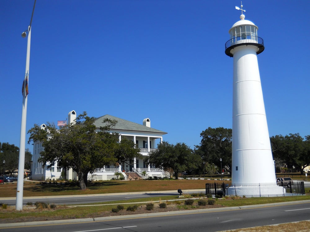 Biloxi Lighthouse on U.S. Route 90 with Visitor's Center in background.