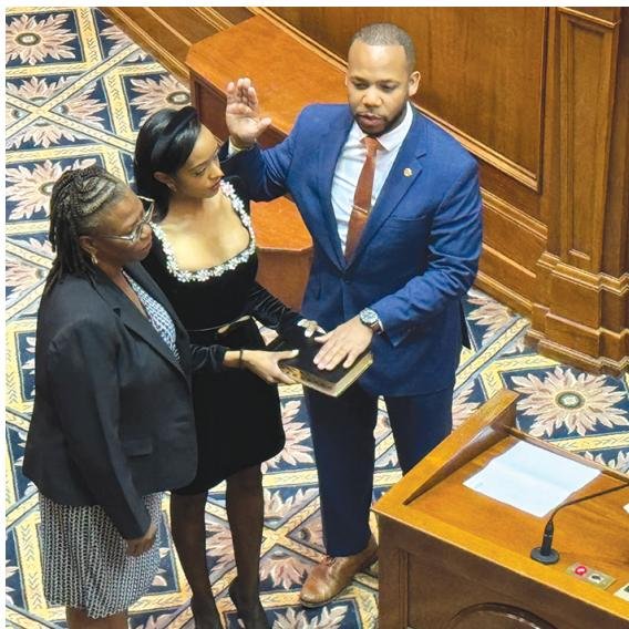 Senator Deon Tedder takes the oath of office. He is joined by his two biggest supporters, his wife and mother.