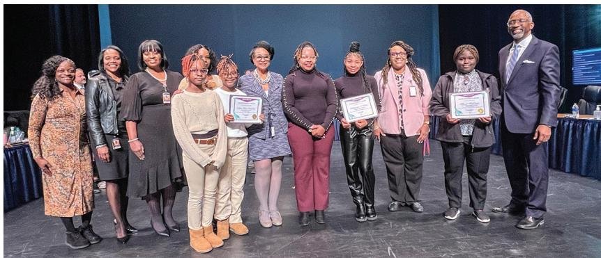 Richland One officials are pictured with middle school MLK Celebration winners