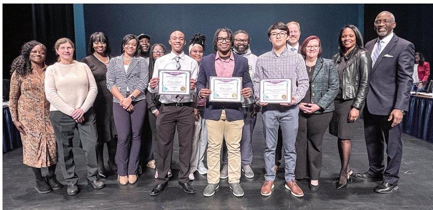 Richland One officials are pictured with high school MLK Celebration winners