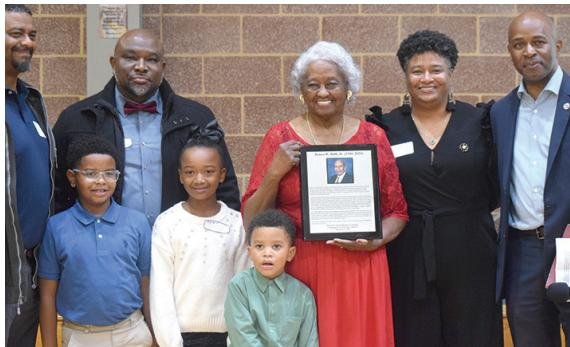 Family members of the late Drew Shark James Ruff pose for a photo with Dr. Donaldson (right).