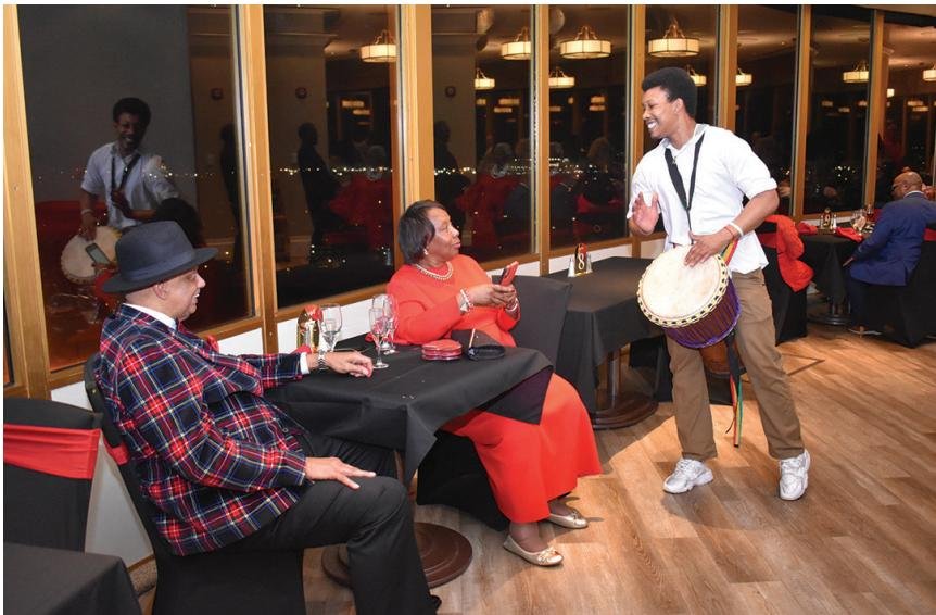 Russell Perkins Jr. plays the African drum for Rev. Dr. Cynthia Walters and Skip Walters.