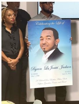 Byron Jackson’s family members display his photo.