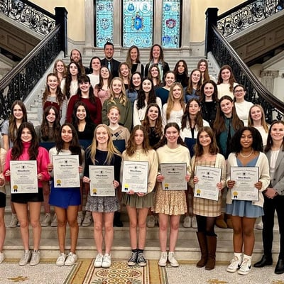 Photo of Oliver Ames girls cross country team at the state house, 2024