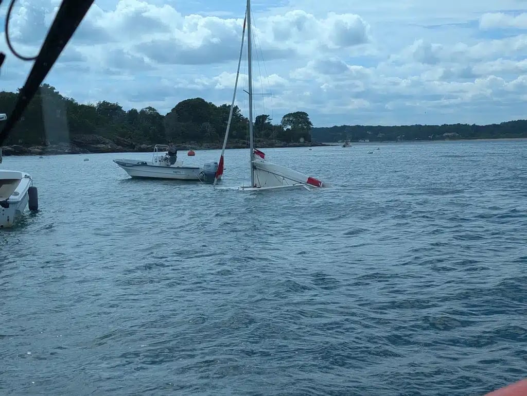 Small sailboat in process of sinking