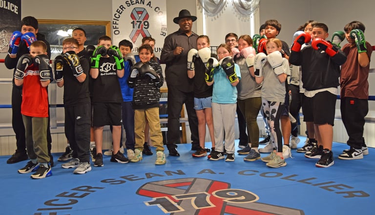 Former Heavyweight Champion of the World Buster Douglas Visits Lowell Police Youth Service Boxing Gym