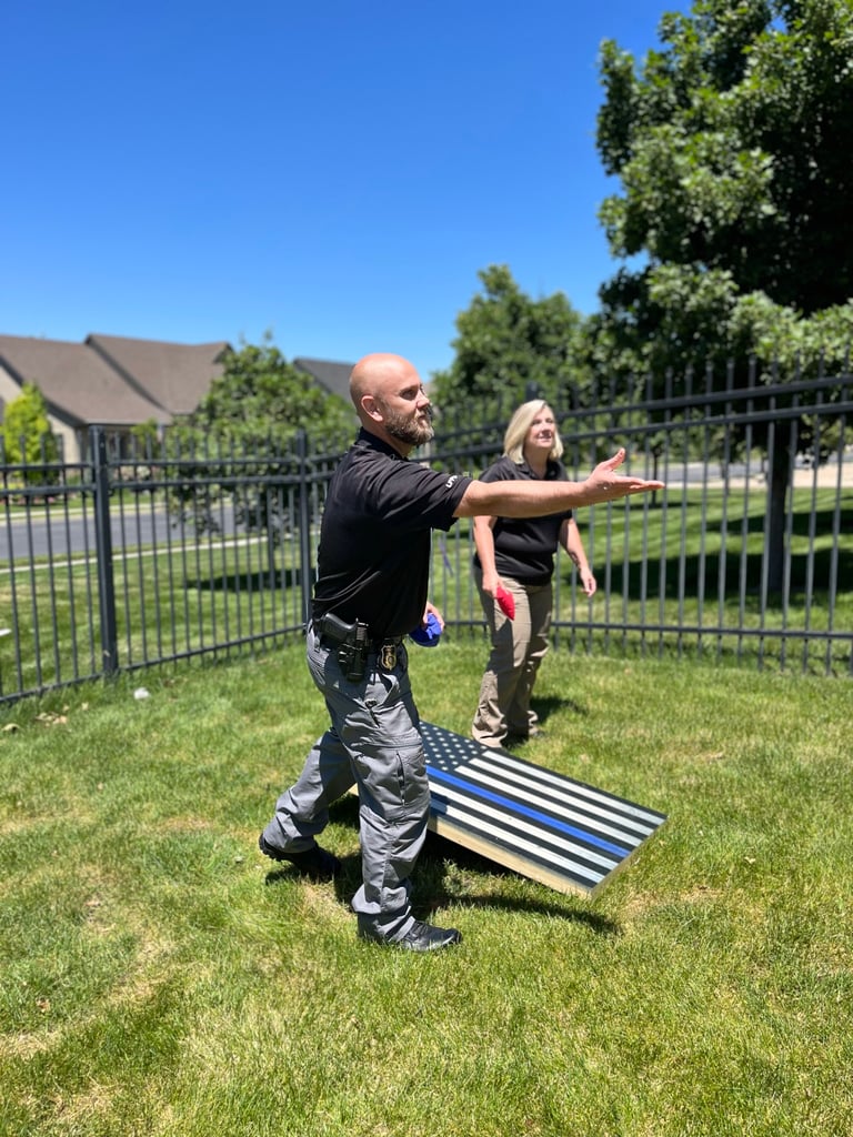 Police officers playing corn hole.