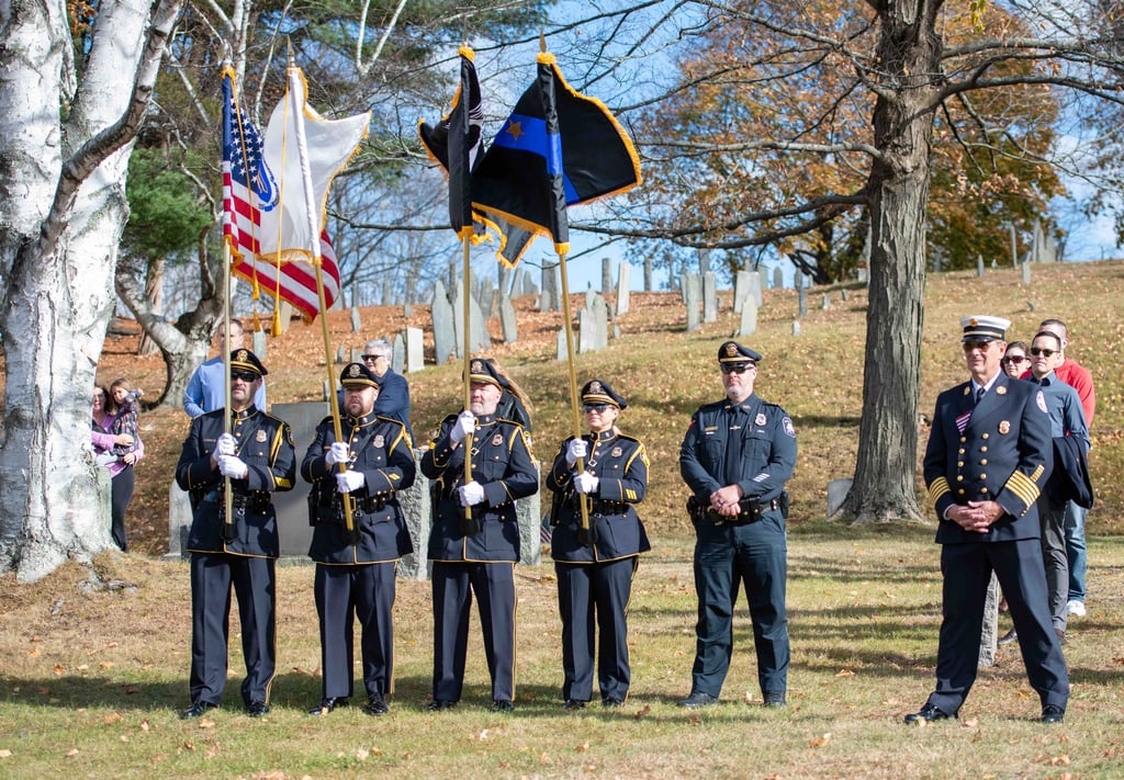 Honor guard members carrying flags at a Veterans Day Event.