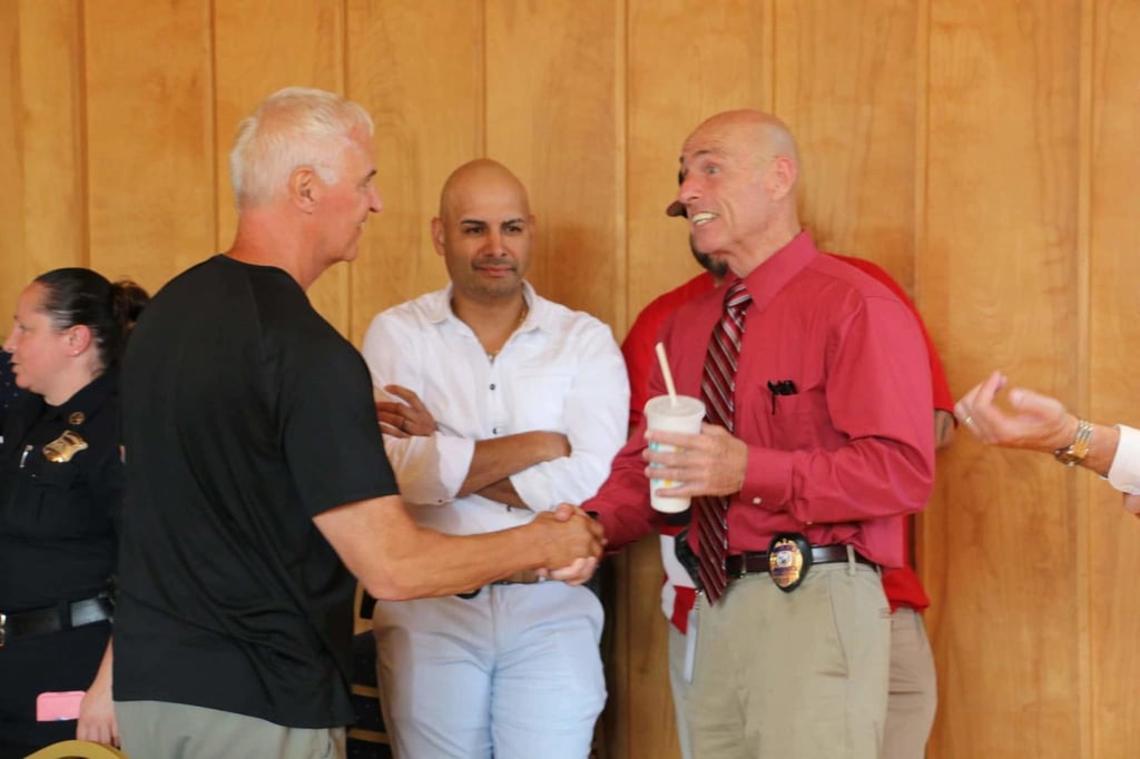 Lt. Korn being congratulated by officers.