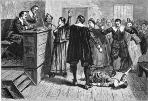 Black & white etching of a courtroom scene from a Salem witch trial.