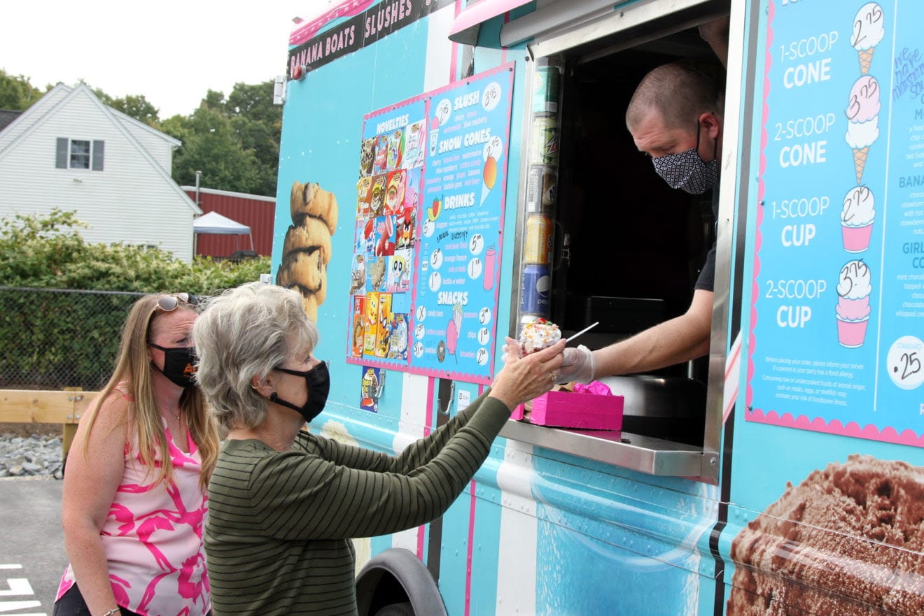 Board of Assessors Administrative Assistant Susan Monahan picks up her ice cream at the window. (Photo courtesy Town of Avon)