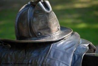 Closeup of the firefighter helmet. The company number is '33'.