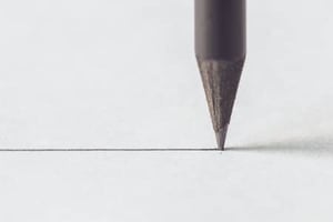 close up black pencil with stroke on white paper