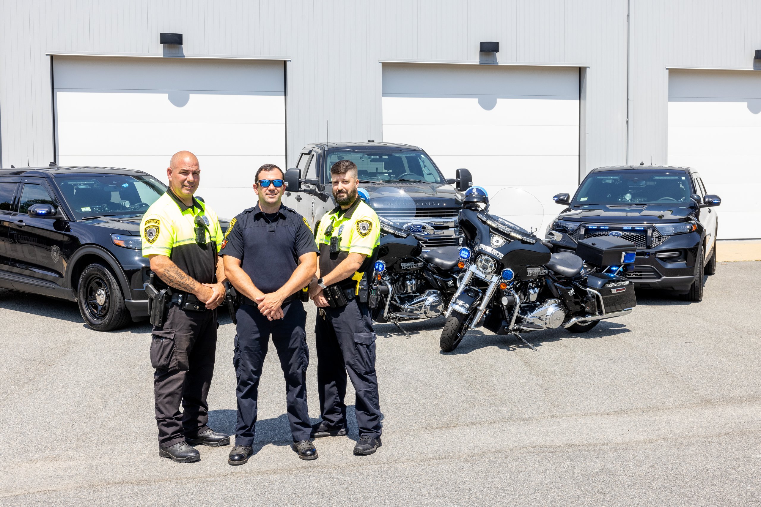 Three officers and patrol vehicles 