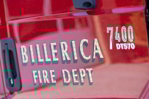 Close up of the Billerica Fire Department logo on the side of a fire engine.