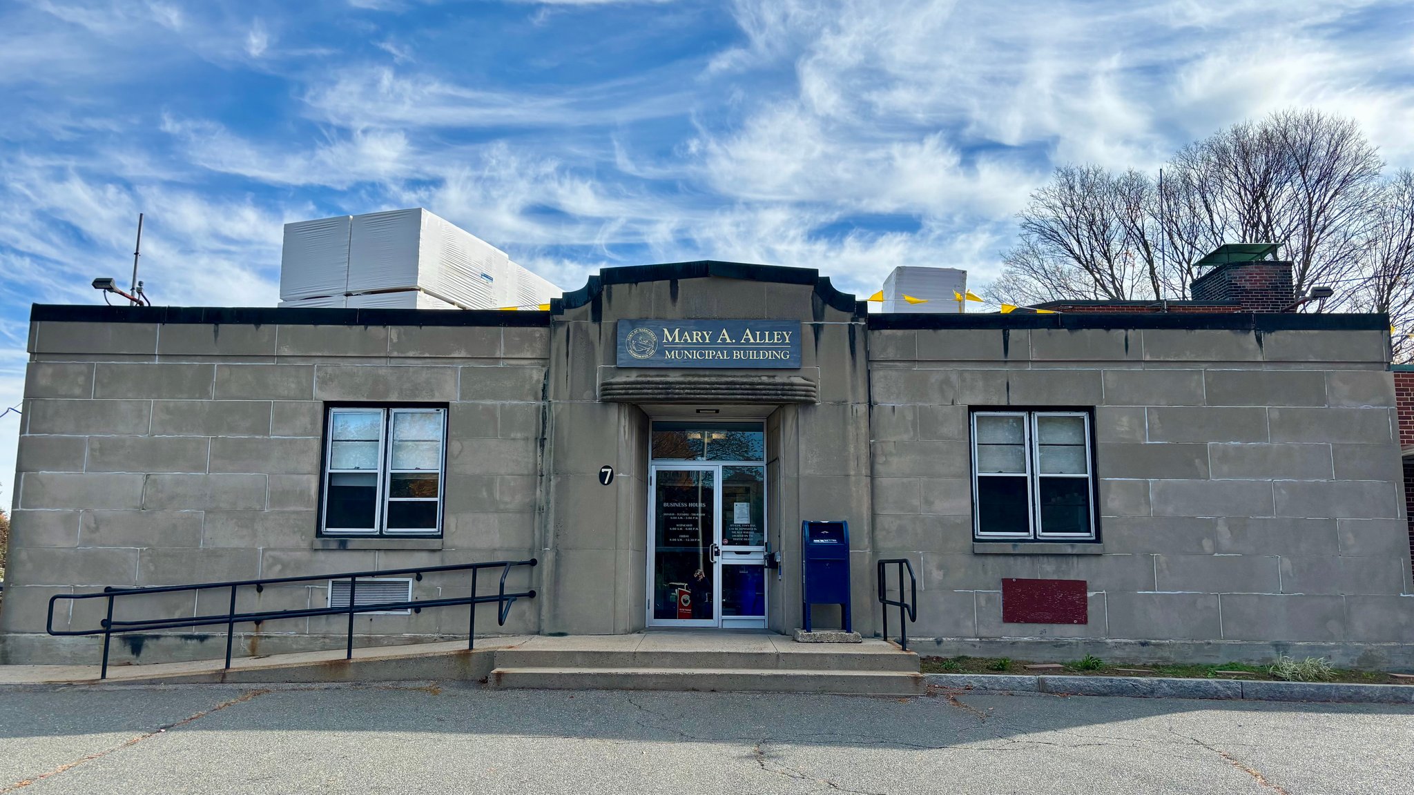 Front of the Mary A. Alley Municipal building with new insulation stacked on roof.