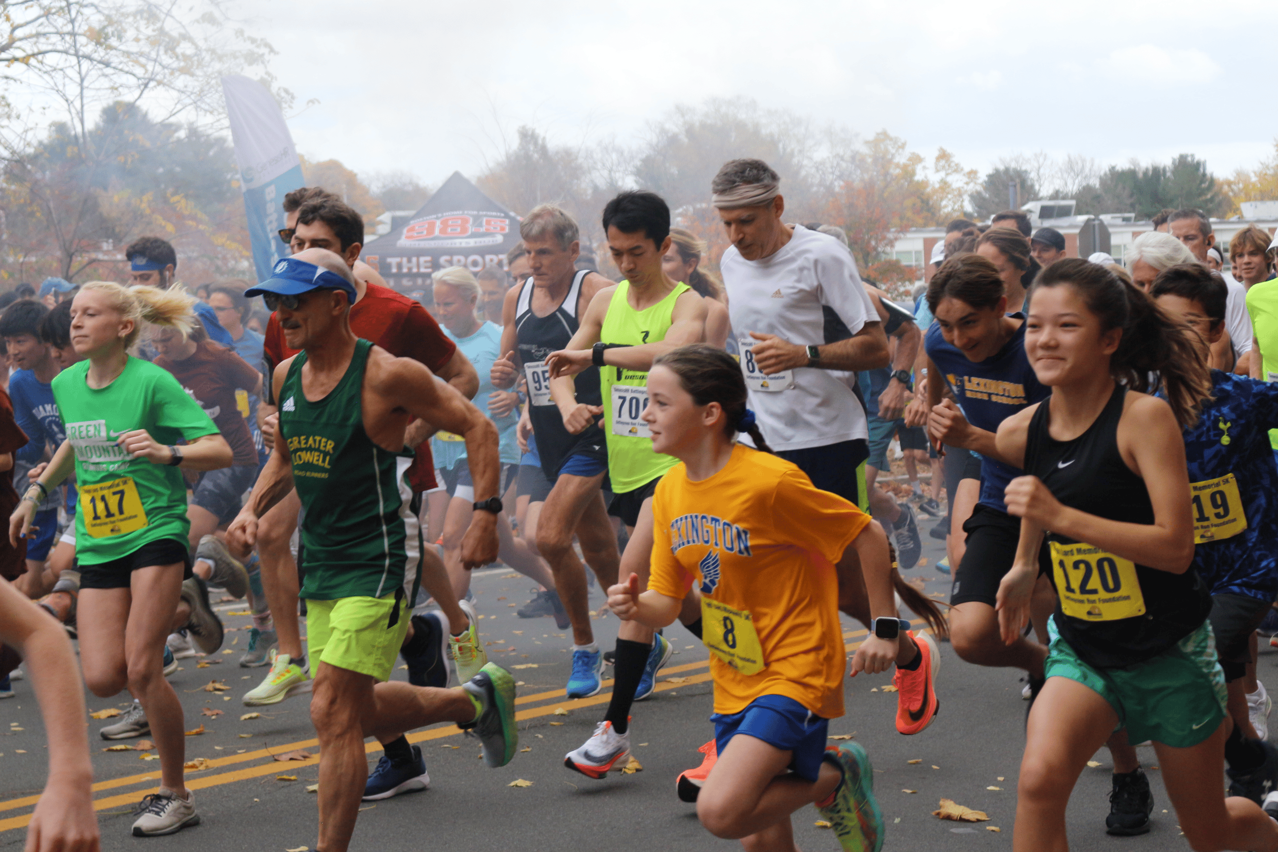 Community members running in a road race.