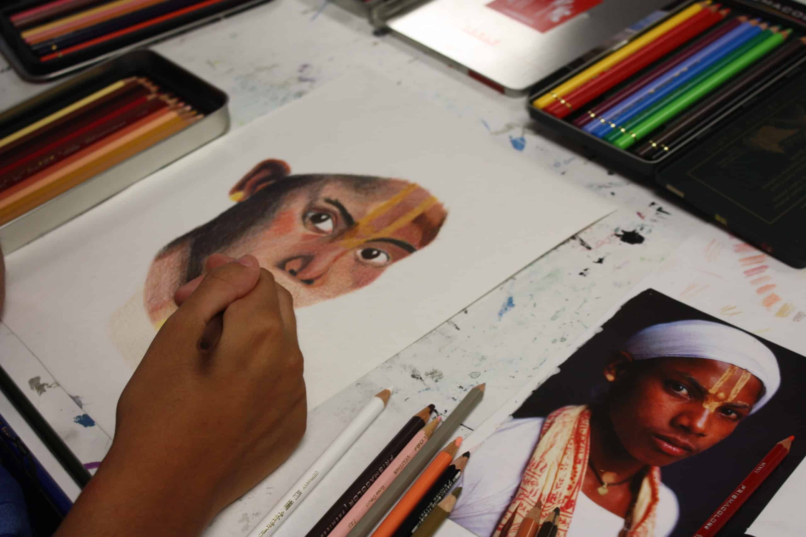 student drawing portrait in class