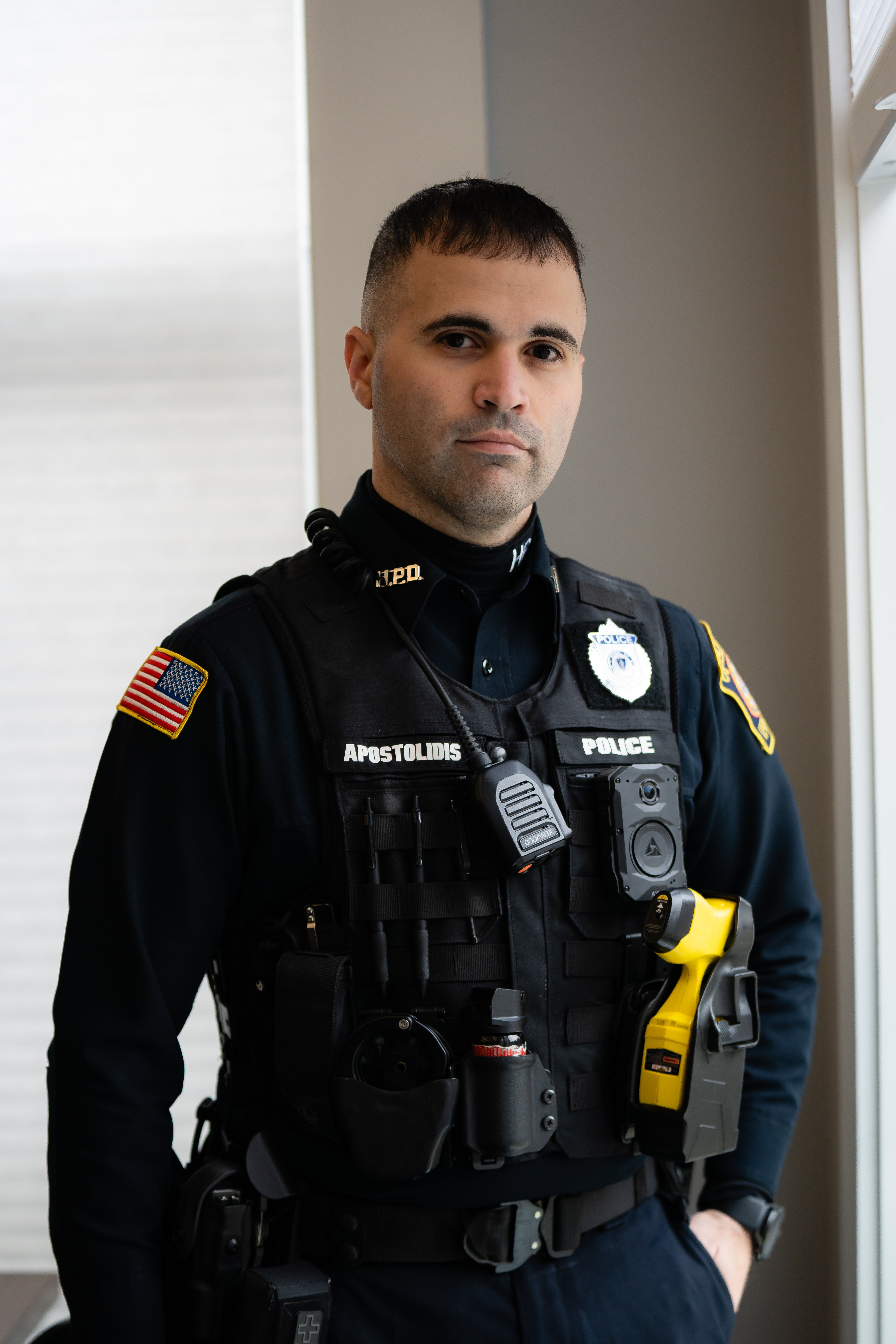 A male Holbrook Police Department member wears a body camera on his uniform.