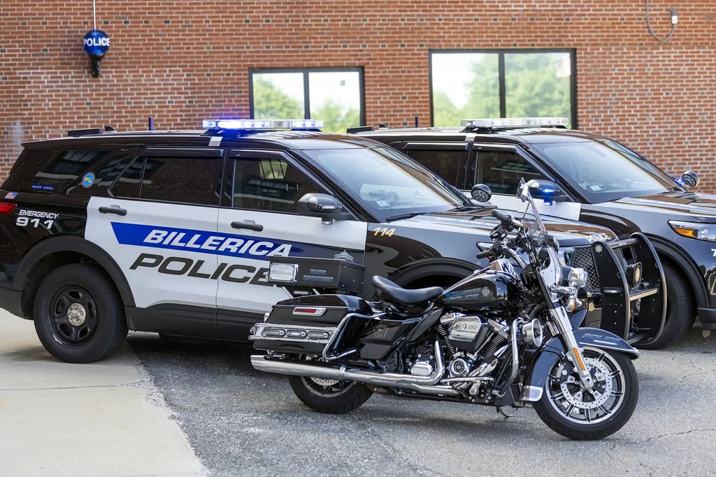 A Billerica Police motorcycle in front of two police cruisers.