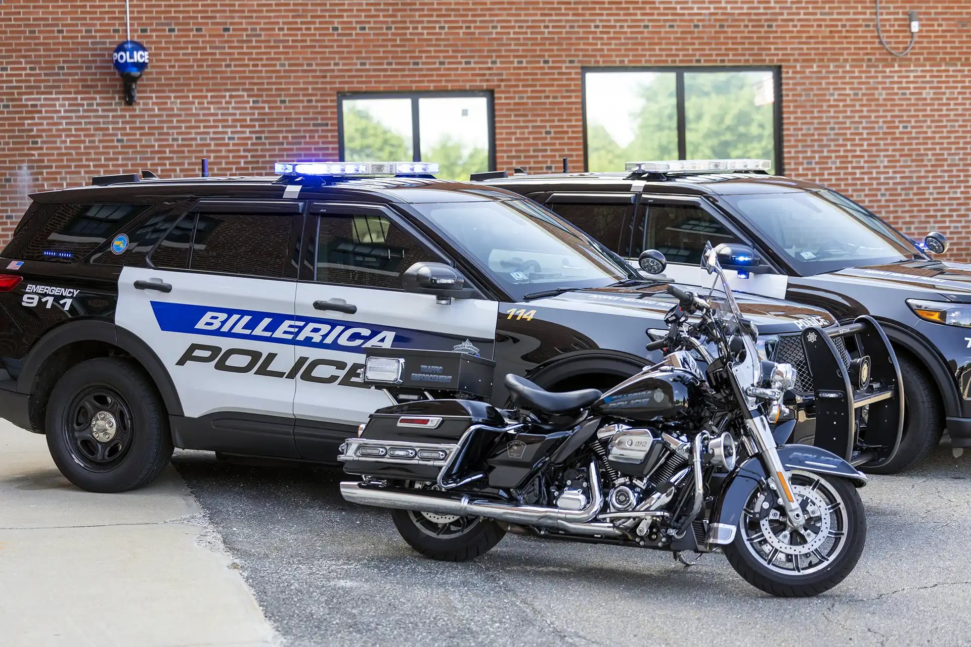 A Billerica Police motorcycle in front of two police cruisers.