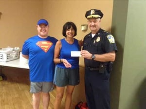 The Melrose Police Department received a $5,000 donation from the Melrose Running Club to support the department's R.A.D. program. Left-to-right: Jason Doucette, Melrose Running Club President, Liz Tassinari, Melrose Run for Women Race Director, and Chief Michael Lyle. (Courtesy Phot