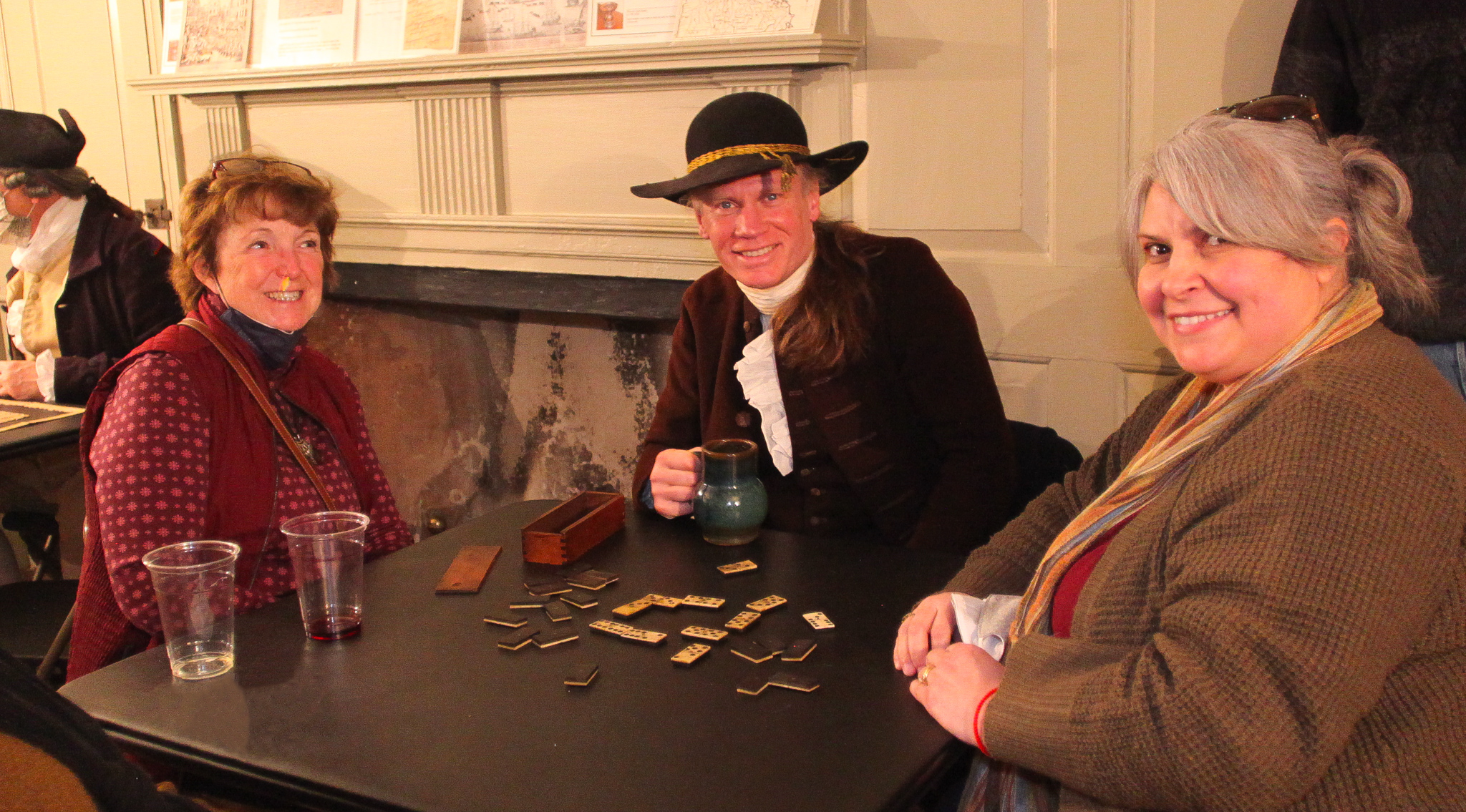 Three adults sit at Buckman tavern enjoying a drink.