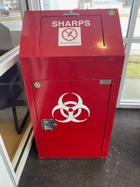 Red hazardous materials and needle drop box.