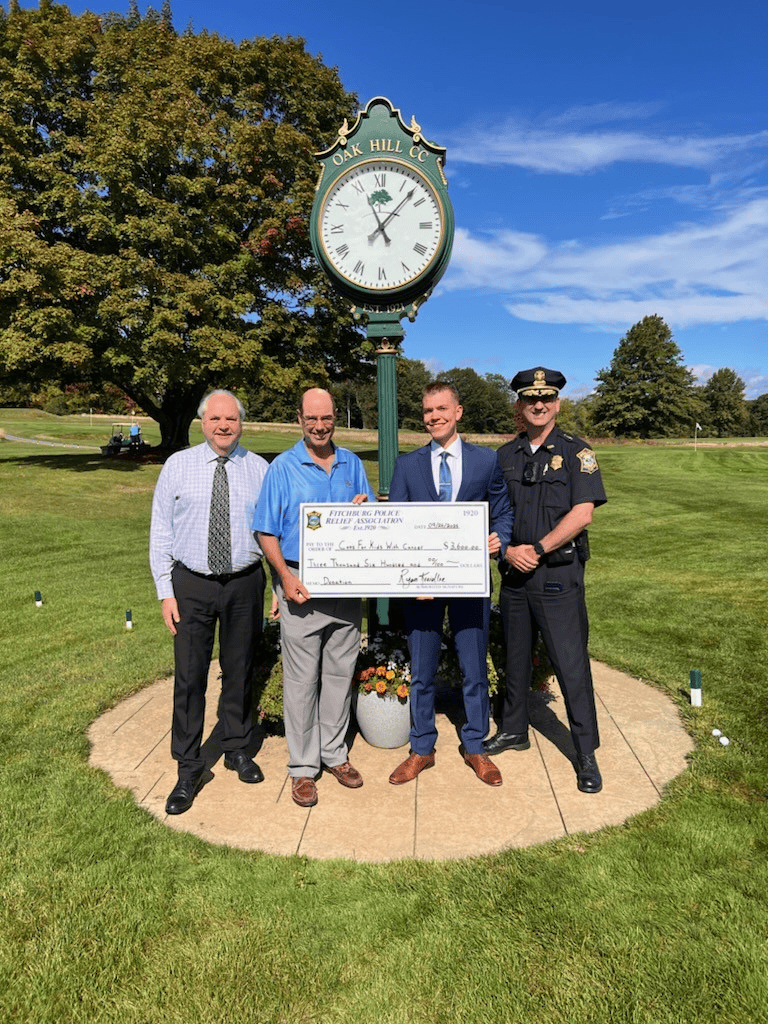 Cops for Kids with Cancer accepts a check for $3,600 from Fitchburg Police Department