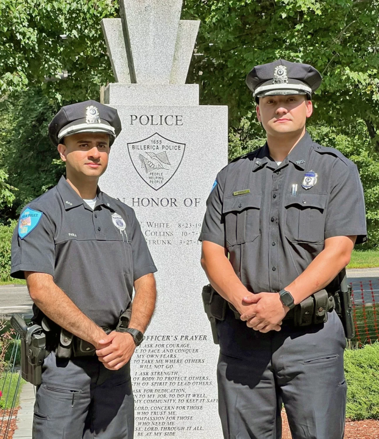 From left, Officer Sukbir Pabla and Officer Derek Coffey stand at the Billerica Public Safety Memorial.
