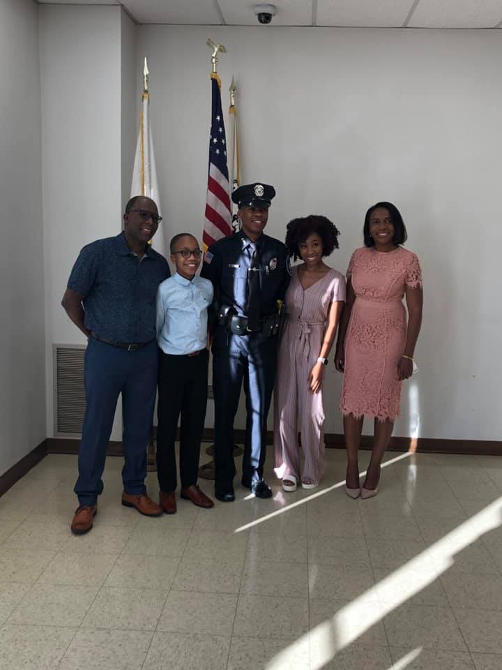 Avon Police Officer Hans Guillaume stands (left to right) with his father Emile Ravix, brother Travis Guillaume, girlfriend Ikiah Decas and mother Marguerite Guillaume after he was sworn in at Avon Town Hall on Thursday, June 25. (Photo courtesy Avon Police Department)