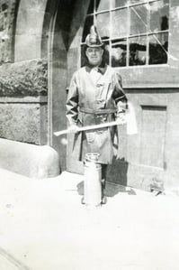 Ladderman Gilbert W. Jones, Ladder 15, with an axe and extinguisher, at quarters at 941 Boylston St., Back Bay, circa 1922.