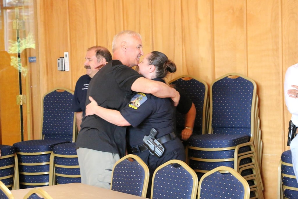 Lt. Korn hugging Officer Scanlon