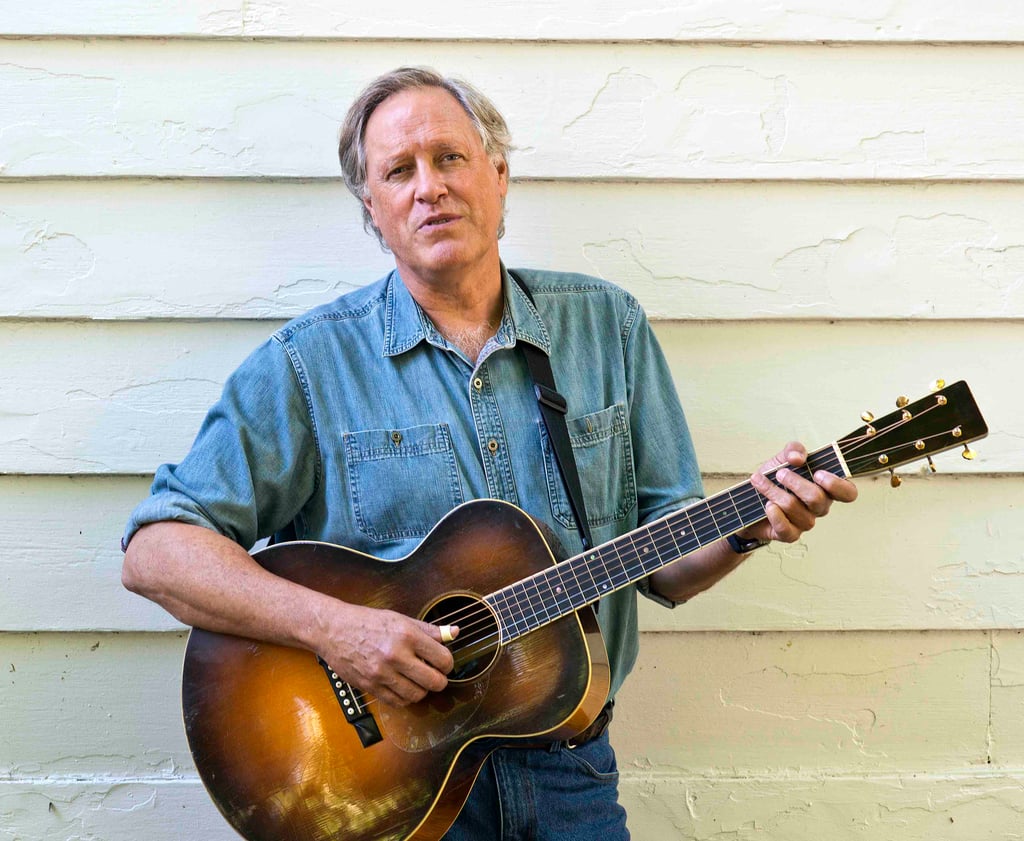 Tom Chapin holding a guitar.