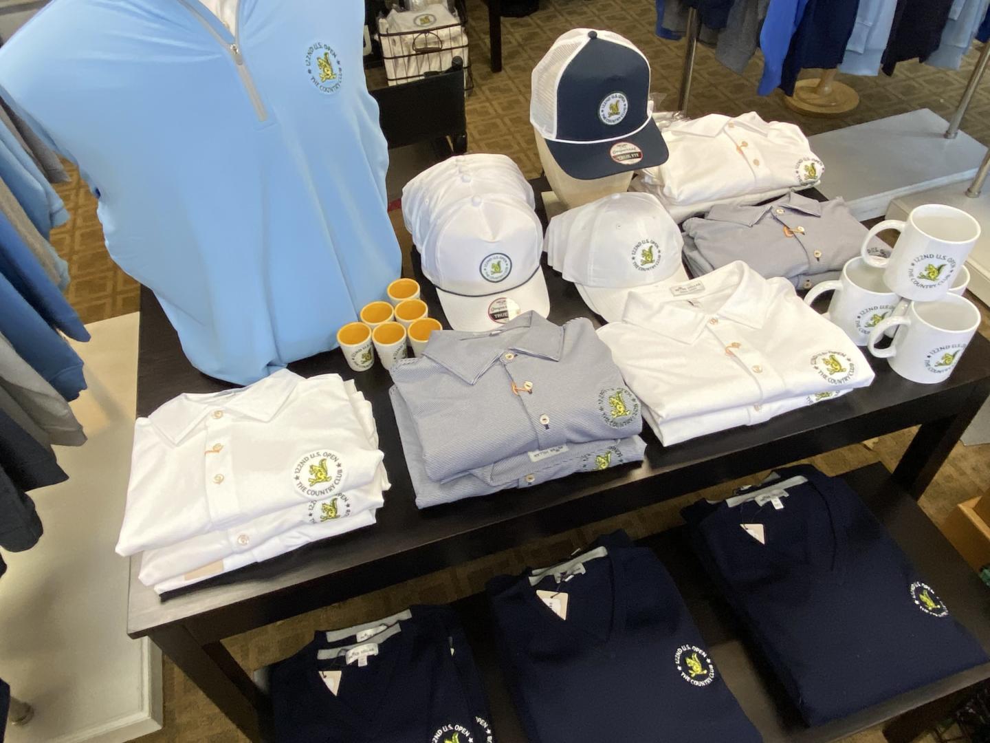 U.S. Open-branded apparel is available in the pro shop of Brookline Golf Course, with proceeds supporting local Brookline non-profits and community groups.