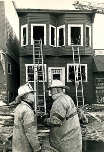 (L) Dist. Fire Chief Vincent Bolger & (R) Dist. Fire Chief John Vahey confer at an unknown location, 1/8/1978.