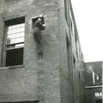 Ladderman Gilbert W. Jones, Ladder 15, training on a pompier ladder at the Drill School, 60 Bristol St., South End, in 1921.