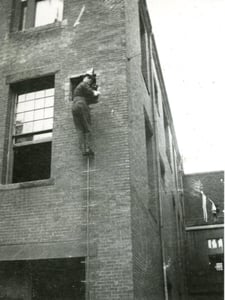 Ladderman Gilbert W. Jones, Ladder 15, training on a pompier ladder at the Drill School, 60 Bristol St., South End, in 1921.